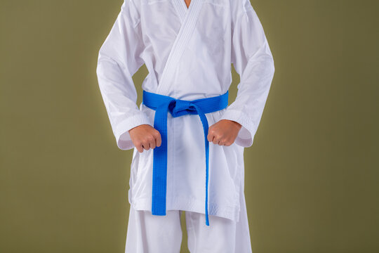 Young karate student holding Heisoku Dachi starting stance with controlled posture. Emphasizes symmetry, focus, and early technique development.