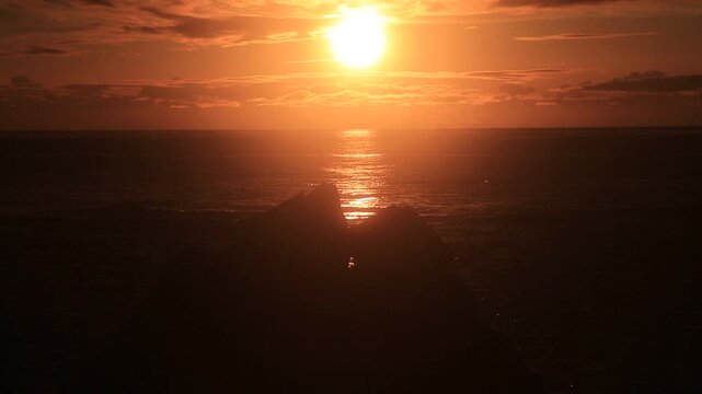 Sunset over the East China Sea with rocky coast in Amami Oshima, Japan