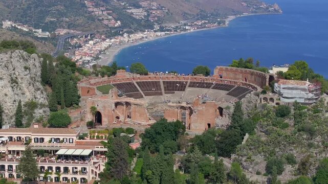 Ancient Theater in Taormina City Aerial view. Roman Amphitheater beautiful Historical Sicilian City. Sicily, Italy.