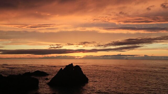 Sunset over the East China Sea with rocky coast in Amami Oshima, Japan