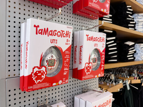 KUALA LUMPUR, MALAYSIA - FEB 02, 2026: Tamagotchi x Uniqlo UT Gen 1 digital pet toy boxes displayed on retail store pegboard shelf.