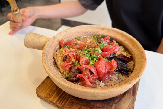 Traditional claypot rice topped with Chinese wax meat and sausages.