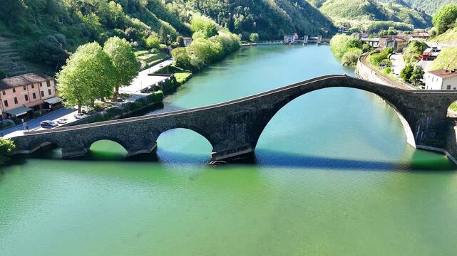 Aerial view of Devil's Bridge Ponte della Maddalena Borgo a Mozzano over Serchio River Tuscany Italy
