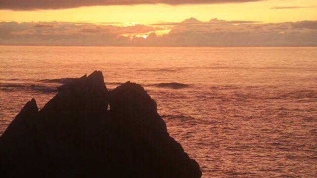 Sunset over the East China Sea with rocky coast in Amami Oshima, Japan