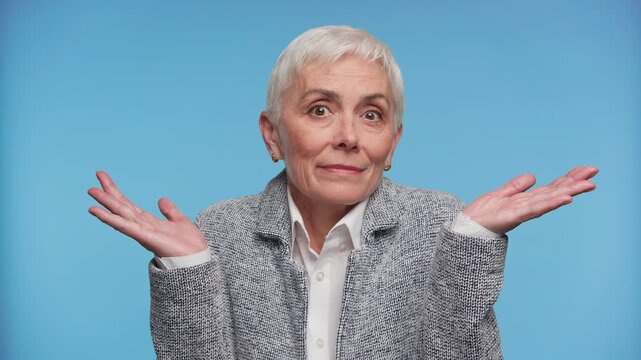 Puzzled Senior Woman Shrugging With Open Hands