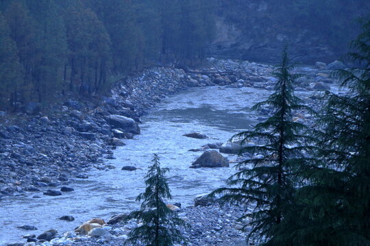 Beautiful Ganga River landscape at Netala near Uttarkashi during monsoon. Scenic view of the Ganga River flowing through the lush green Himalayan landscape.