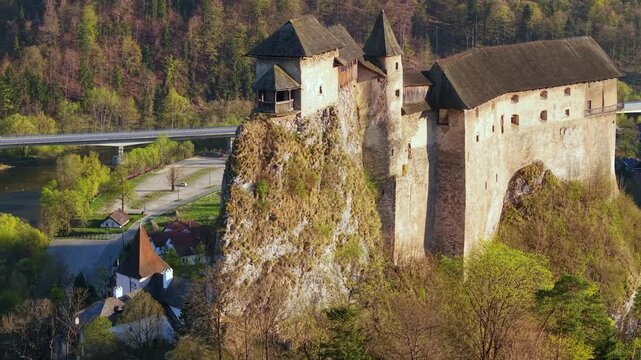 Medieval Orava Castle perched on a high rock above the Orava river in Slovakia. Aerial drone view of a fortress surrounded by nature