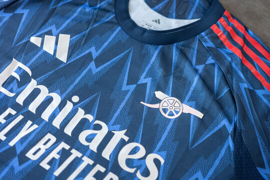 Bangkok, Thailand - 7 May 2026; Adidas is present the Arsenal FC away team jersey for season 2025-2026. It coming in deep blue color with thunderbolt pattern and metallic silver emblem. Close-up.