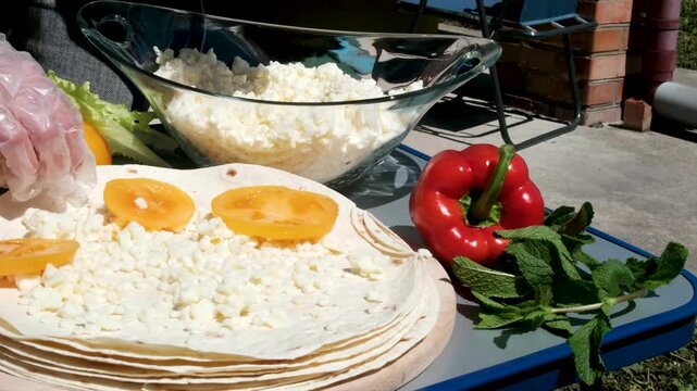 the process of cooking pita bread on the grill pita bread with cheese and yellow tomato cook fry wrap.