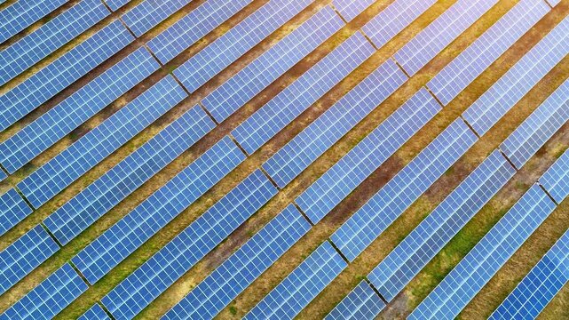 Drone view capturing endless rows of solar panels under sunlight, symbolizing clean energy innovation, ESG commitments, and the transition away from fossil fuels during extreme climate conditions. 4k.