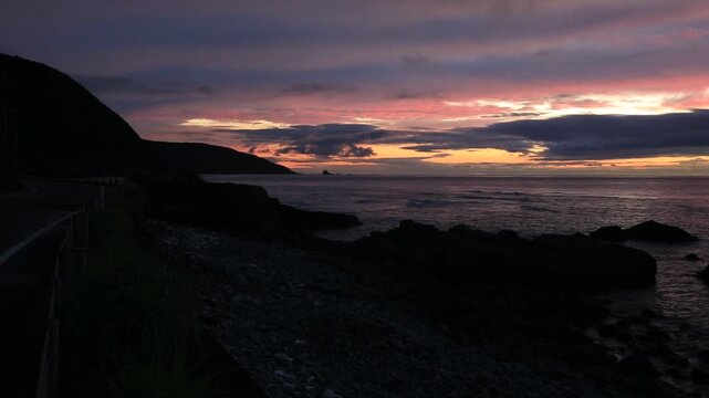 Sunset over the East China Sea with rocky coast in Amami Oshima, Japan