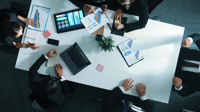 Top down aerial view of smart businessman use vr headset to enter virtual world at meeting while diverse business people send financial information and data analysis graph in database. Directorate.