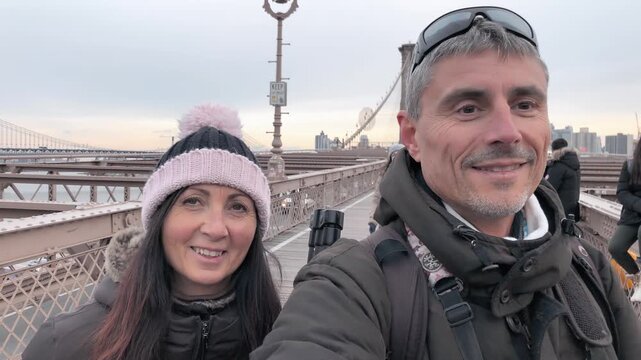 NEW YORK CITY - DECEMBER 2018: Cars traffic and people walking over Brooklyn Bridge from Manhattan and Brooklyn. Slow motion
