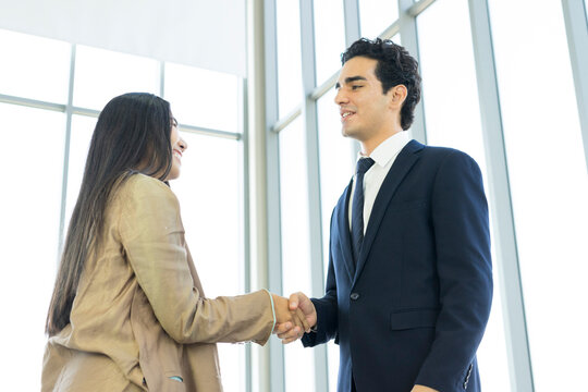 Young business people are shaking hands after a business deal. Successful negotiations or interview.