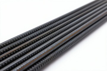 Fototapeta premium Straight steel rebar rods arranged in parallel on clean white surface. Textured, ribbed pattern visible, indicating strength, material for construction projects, industrial applications. Useful for