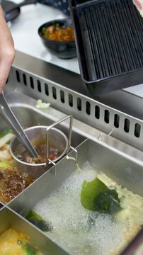 Raw Beef Slices Dipped into Boiling Shabu Shabu Hot Pot Soup