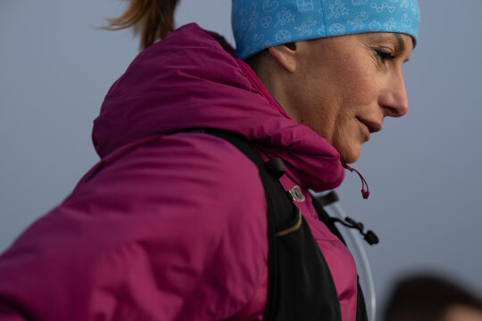 Determined Woman Hiker In Pink Jacket And Blue Beanie Outdoors On A Cold Morning Hike