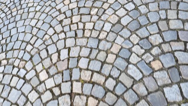 Close Up View of Traditional Fan Patterned Cobblestone Road in France