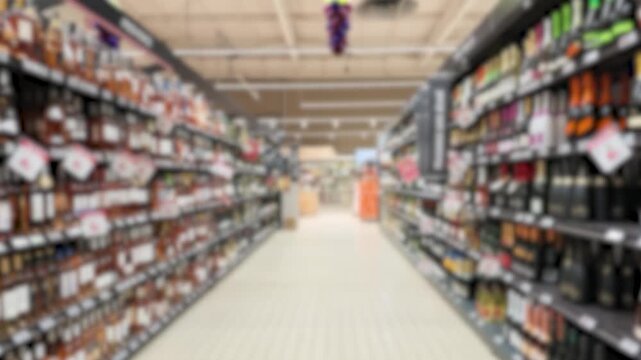 Blurred View Moving Through a Supermarket Wine and Liquor Aisle