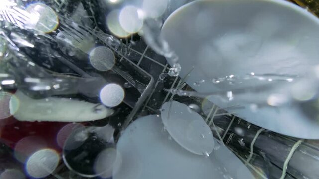 Top Down View from Rotating Arm Inside Dishwasher with Water Spray