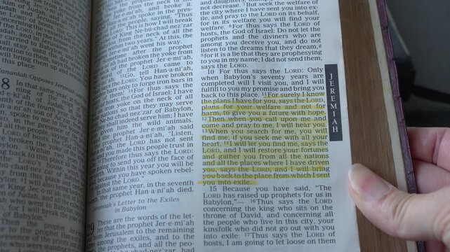 Holy Bible open up to the book of Jeremiah of the old testament, zooming into Chapter 29 verse 11 on The Lord plans to prosper and give hope. New Revised Stan