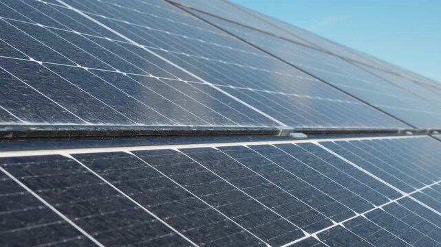Dirty photovoltaic cells on solar panel with dust needing cleaning service for efficiency optimization. Maintenance for better performance and investment payback at renewable power plant closeup.