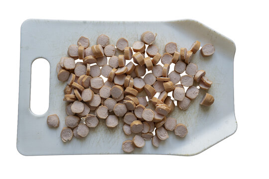 Isolated sliced sausages on a white cutting board, transparent background