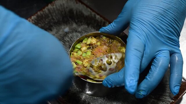 Chef preparing a fresh salmon and avocado tartare