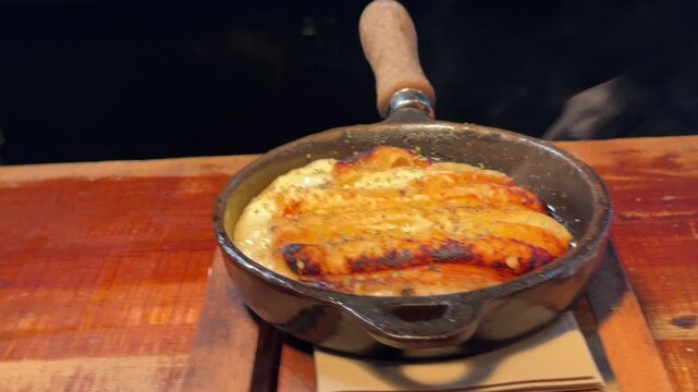 Steaming hot pan of provolone cheese with oregano
