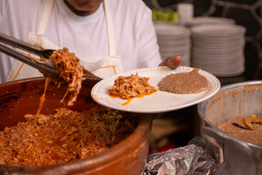 Traditional Mexican birria meat preparation and serving process, close up