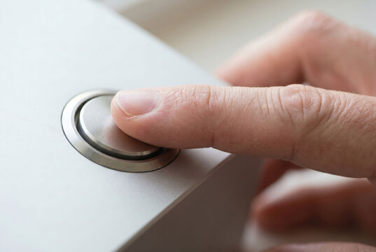 Hand pressing minimalist tactile button