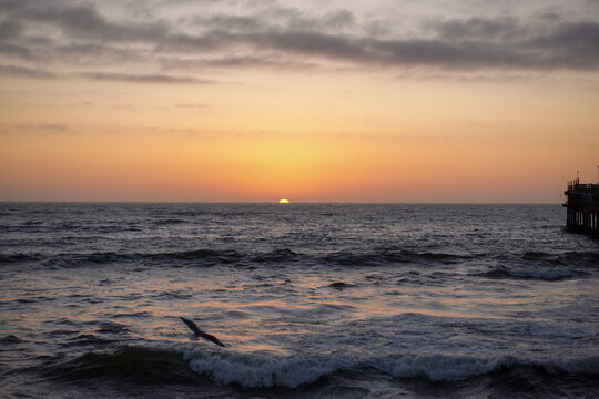 As the sun sinks beyond the Atlantic, the waterfront of Swakopmund&nbsp;glows in warm light, where ocean mist, silhouettes, and evening colors merge into a calm coastal scene.