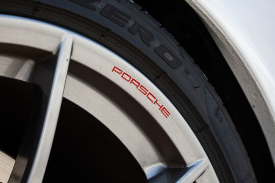 Zurich, Switzerland, April 19, 2026. A close up shot of a silver alloy wheel with red Porsche branding on a white sports car at the Albisguetli Classics.