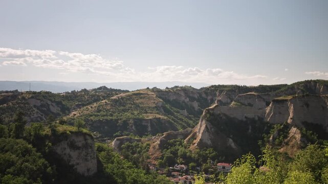 4K beautiful, panoramic landscape view with a scenic, serene skyline and clouds in the rocky mountains and peaks in the rural area around the village of Melnik in Bulgaria, Balkans, Eastern Europe.