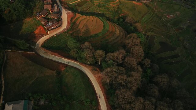 Sapa, Lao Cai Province, Vietnam - A Scenic View of a Homestay Nestled Amidst Terraced Rice Fields, With a Winding Road Leading Through the Lush Landscape - Bird's Eye View