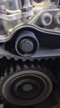 Timing belt engine gear closeup inside dusty vehicle motor block during diagnostic repair service
