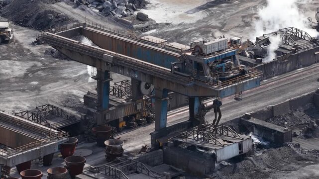 Gantry crane transporting hot slag at steel mill industrial site