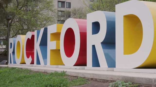 Smooth cinematic gimbal dolly up shot of Rockford Illinois city sign captured outdoors with stabilized vertical camera movement.