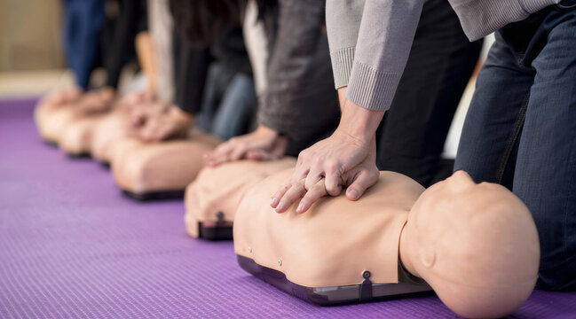 CPR training class practicing life saving chest compressions