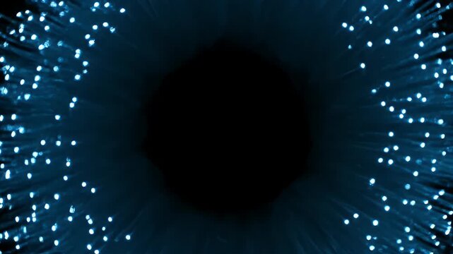 Blue fiber optic lights shimmering in a circular pattern around a dark black center.