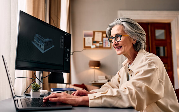 Senior woman architect using 3d design software in home office.