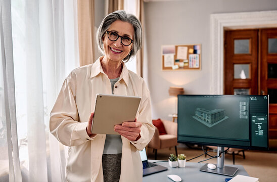 Senior architect with tablet in home office 3d design workspace