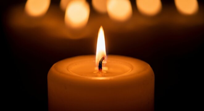 Burning candle flame darkness