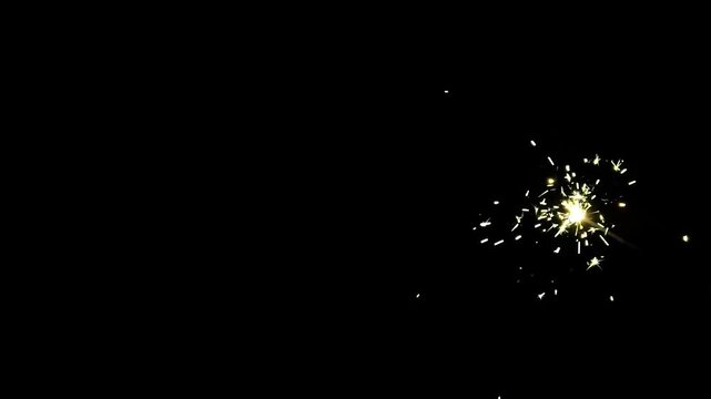 Orange-gold sparks shooting upwards against a dark black background, for celebrations or industrial