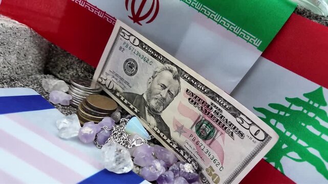 An American fifty-dollar bill rests amidst global flags and various raw crystals.