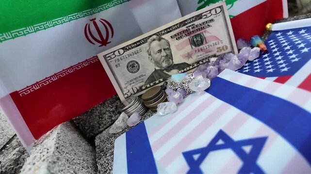 Middle Eastern and American flags converge around a fifty-dollar bill and crystals.