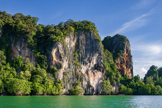 Spectacular golden sunset over the limestone cliffs of Railay West Beach in Krabi, Thailand