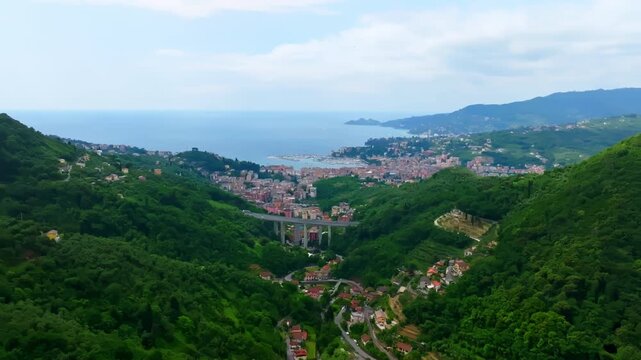 Aerial establishing view sideways in front of Rapallo city, at Gulf of Tigullio, Italy