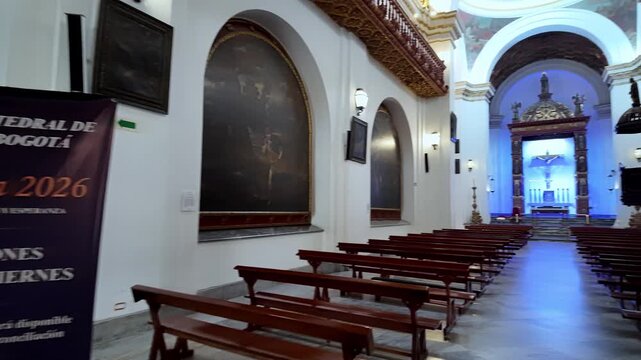 Interior perspective showing the rows of traditional wooden benches and the impressive arches of the neoclassical cathedral.