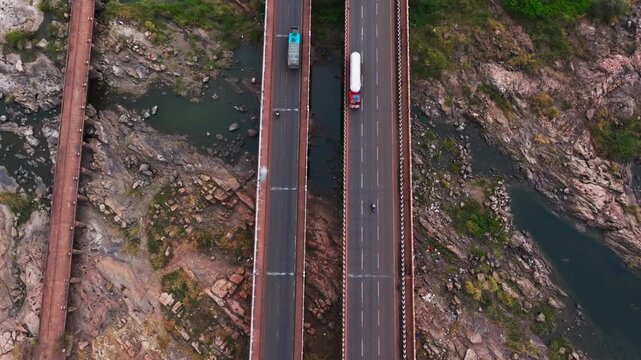 Munirabad Tungabhadra Bridge with Tungabhadraa Canal Bridge, Tungabhadra right canal, crop field lands and Wind Turbines at hosapete, karnataka, india. day time, tilt up shot, drone shot, 4k.